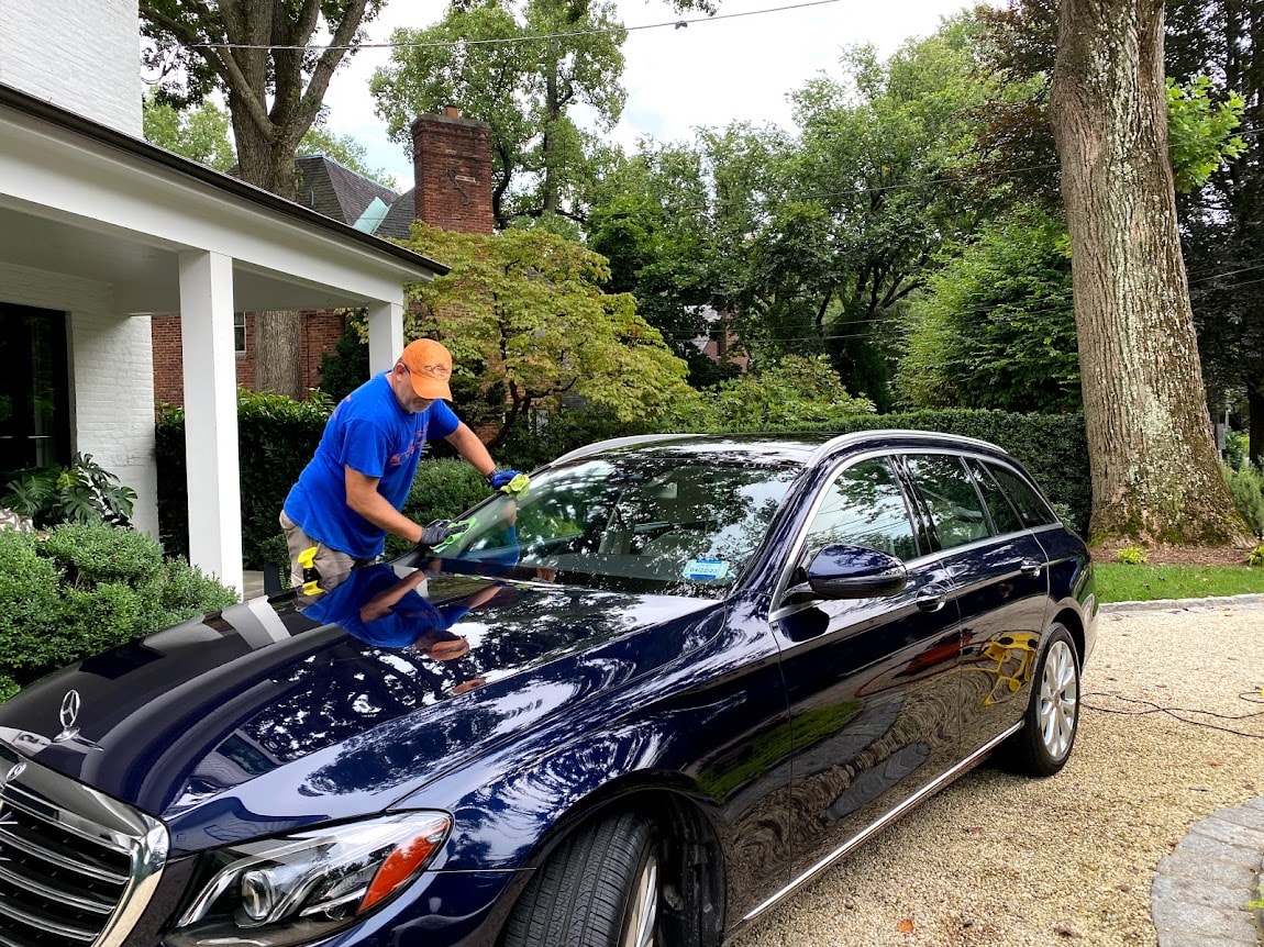 AGV Mobile Car Detailing — Alberto washing a navy blue Mercedes sedan in a residential driveway